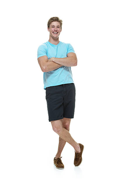 istock Happy young man standing with arms crossed 498645015