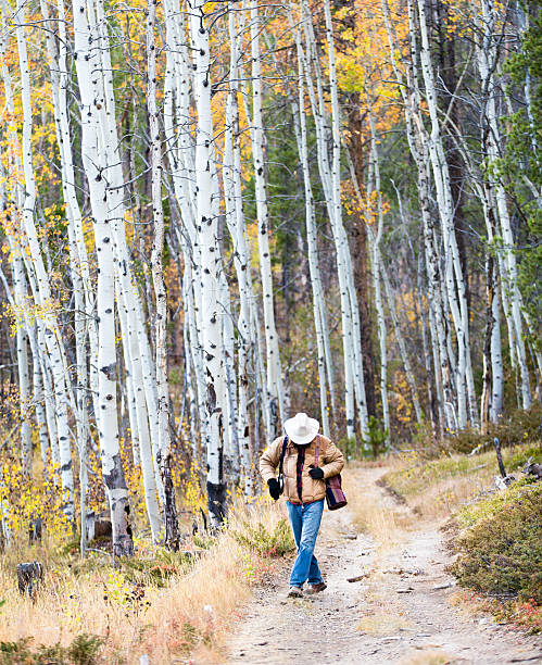 istock Outdoorsman carries mat while walking in woods 498647883