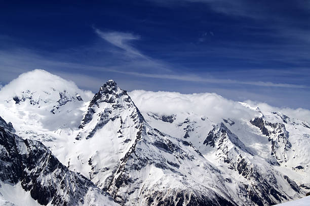 istock Snowy mountains and blue sky with clouds 498647923