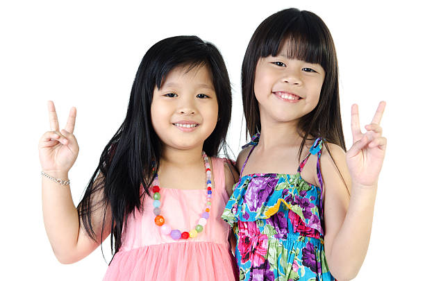 portrait of two asian happy sisters having fun stock photo