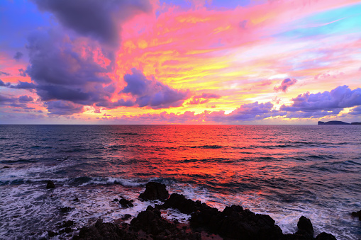 pink sky with clouds over Alghero coast, Italy