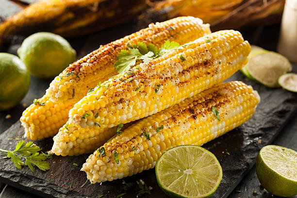 Delicious Grilled Mexican Corn Delicious Grilled Mexican Corn with Chili, Cilantro, and Lime corn photos stock pictures, royalty-free photos & images