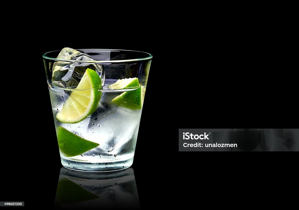 Vodka with lime and ice Vodka lime with ice in rocks glass on black background including clipping path Vodka Stock Photo