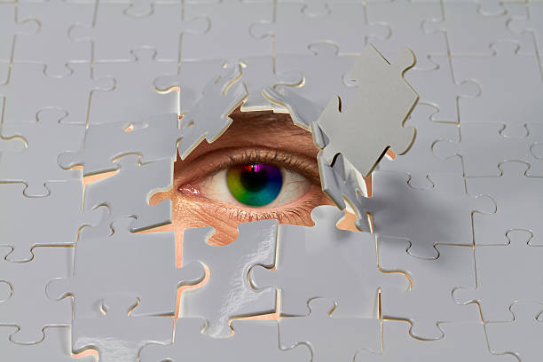 Puzzle An eye looking out from a hole in a puzzle. purpur stock pictures, royalty-free photos & images