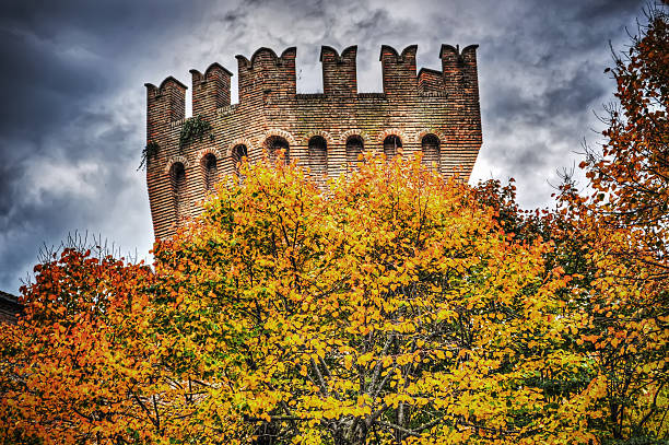 yellow leaves with Corinaldo tower in the background hdr tone mapping effect