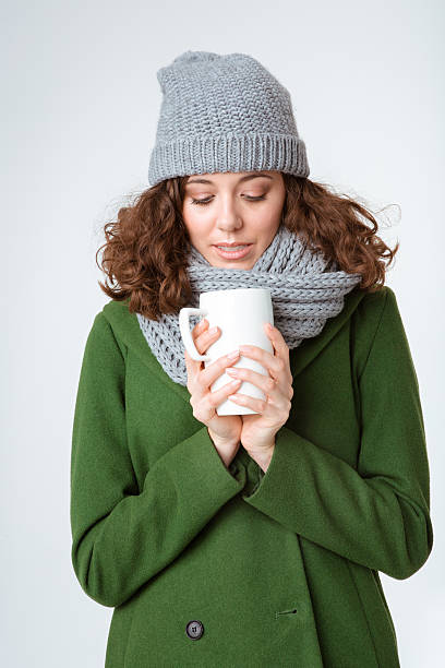 istock Woman in winter cloth holding cup with coffee 498655528