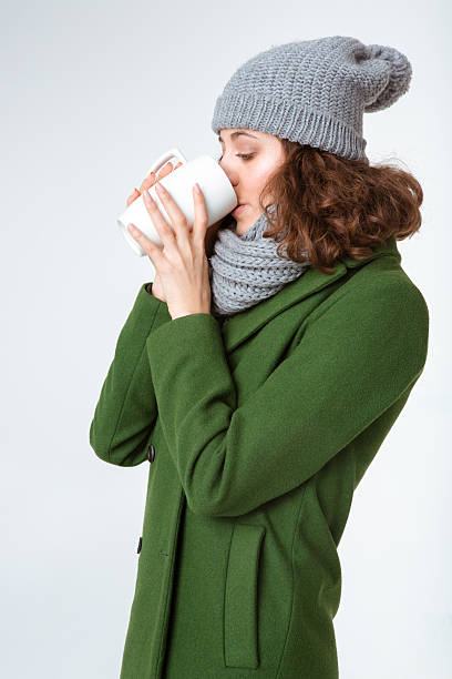 istock Woman in winter cloth drinking coffee 498655584