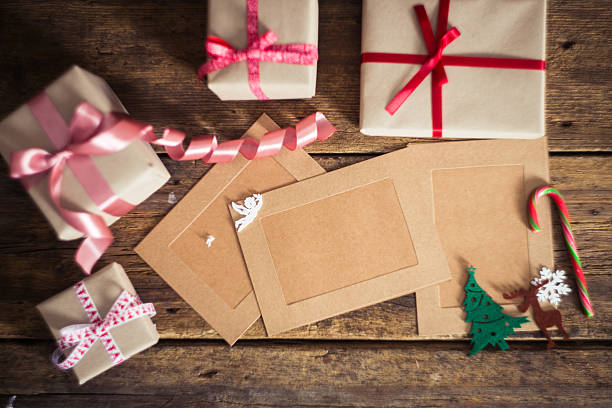 istock Christmas gift box with cards  on a wooden background 498657094