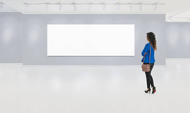 istock Lonely young woman wathches blank board 498657716
