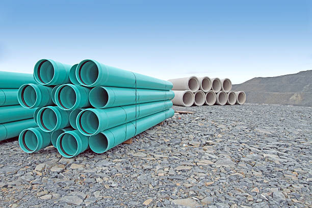 Stacked Water And Sewer Pipe On New Road Construction Site stock photo