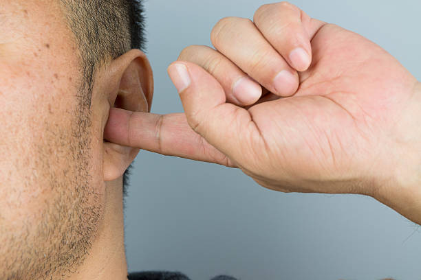istock Man cover your ears with your fingers 498658684