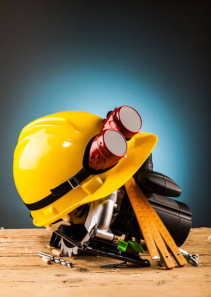 istock yellow helmet and wood mounting tools 498659060