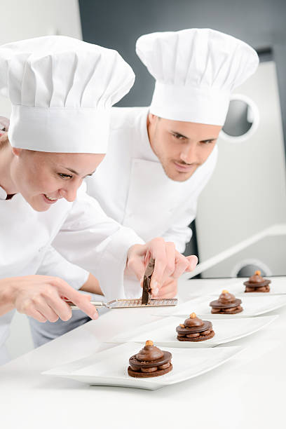 istock cheerful young woman professional pastry cook at work 498659268