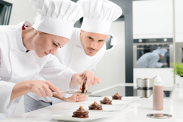 istock cheerful young woman professional pastry cook at work 498659394
