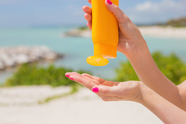 istock Woman pouring sunscreen in hand 498659482