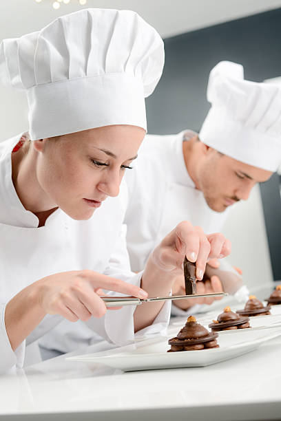 istock cheerful young woman professional pastry cook at work 498659892