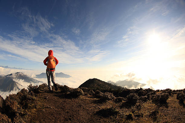 istock young woman hiker on beautiful rolling clouds mountain peak 498660654