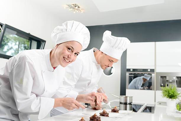 istock cheerful young woman professional pastry cook at work 498661256