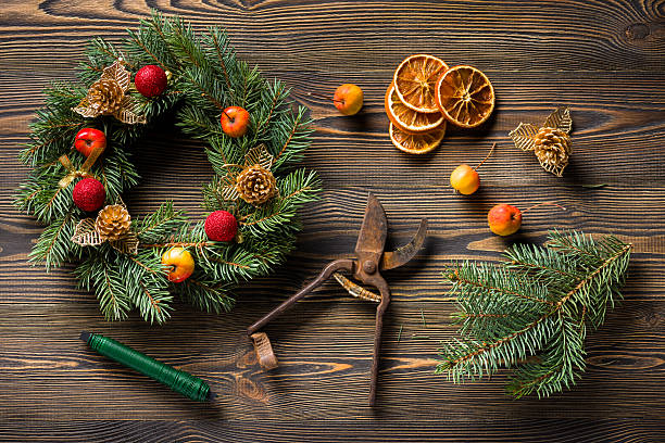 istock Christmas wreath on brown wooden table top view 498661862