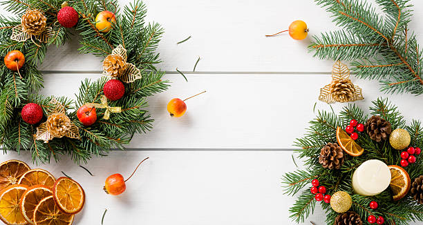 istock Christmas wreath on white wooden table top view 498662082