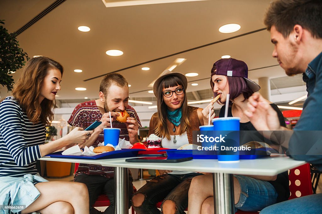 Friends In Mall Hipster Friends In Mall Eating Fast Food Shopping Mall Stock Photo