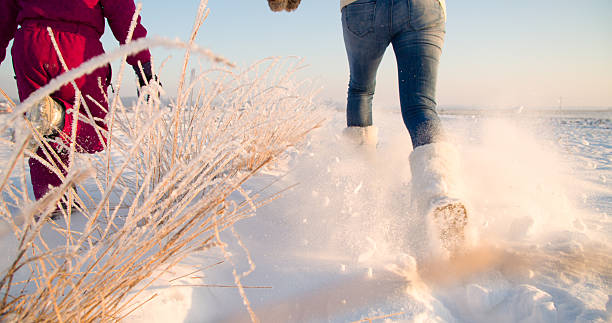 istock Mother And Daughter Running In Snow 498662878