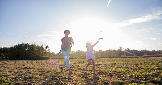 istock Mother And Daughter Running In The Meadow 498663090