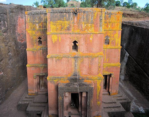 Lalibela, Ethiopia: rock-hewn Church of Saint George Lalibela, Amhara region, Ethiopia: fron view of the rock-hewn Church of Saint George / Biete Giyorgis - carved from red volcanic rock in the shape of a cross - 12th century - the most famous of the eleven monolithic churches in Lalibela - Ethiopian Orthodox Tewahedo Church - UNESCO world heritage site - photo by M.Torres the church of saint george lalibela ethiopia stock pictures, royalty-free photos & images