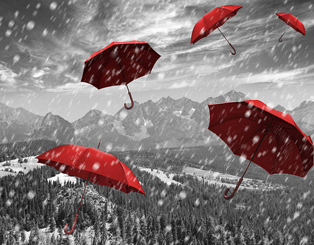 istock flying red umbrellas in the mountains during a storm 498665953