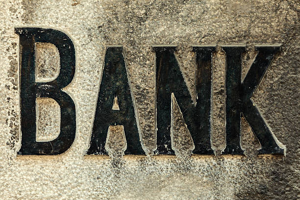 istock Retro styled image of an old stone bank sign 498666155