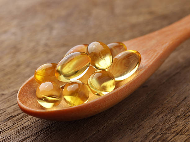 istock Fish oil capsules in a spoon 498667577