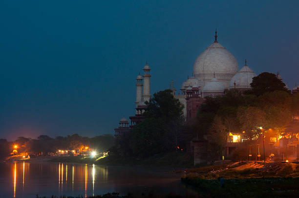 istock taj mahal at sunset mirroring in the lake 498668543