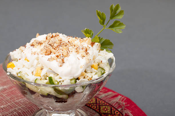 istock Salad with chicken meat, prunes, cucumbers, boiled egg, walnuts 498669017