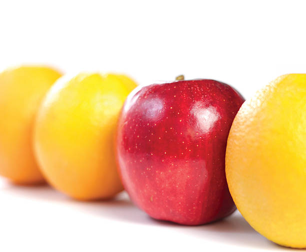 Apple and Orange on white background Apple and oranges in a row on a white background with shallow depth of field. def picture photos stock pictures, royalty-free photos & images