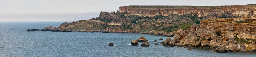 Panoramic shot of the cliffs at Golden Bay in Malta