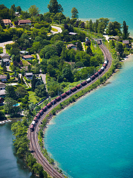 Freight train running aside the lake stock photo