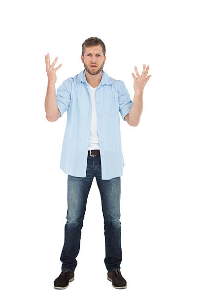 istock Handsome man posing with hands up and looking at camera 498681639
