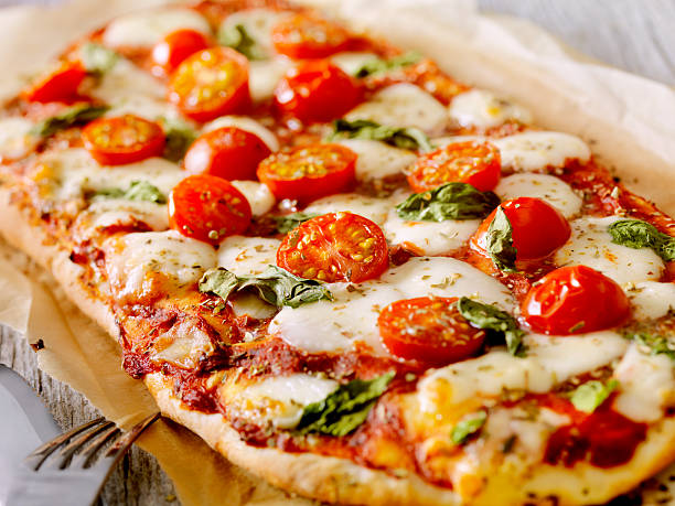 Margherita Flat Bread Pizza Margherita Pizza with Fresh Mozzarella,Tomatoes and Basil on Thin Flat Bread - Photographed on a Hasselblad H3D11-39 megapixel Camera System flatbread stock pictures, royalty-free photos & images