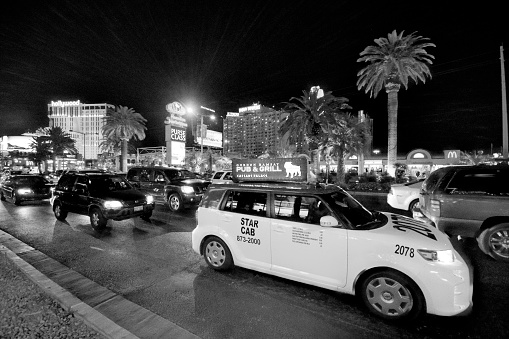 Las Vegas, United States - April 7, 2014: No filters used on this image, this was taken at night with a triple exposure and shows the Las Vegas strip with  the many taxis and traffic at night outside Miracle Mile shopping centre. This image is near the New York New York hotel and is converted to Black and White. 