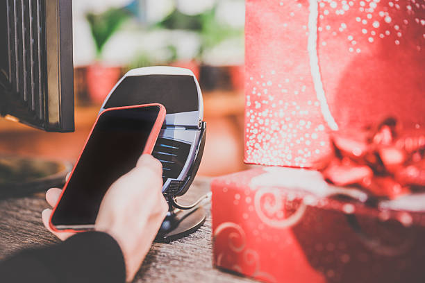 istock Woman Paying With NFC Technology on Smart Phone in Store 498685288