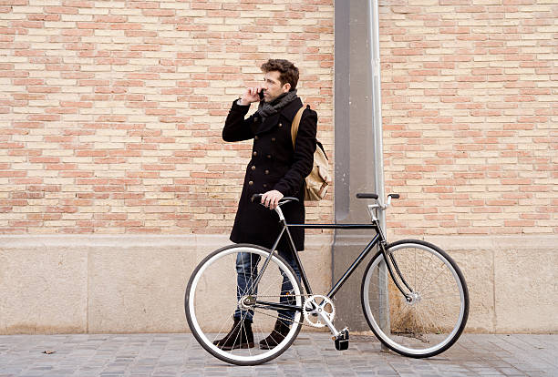 istock young man with bicycle speaking on the telephone 498685488