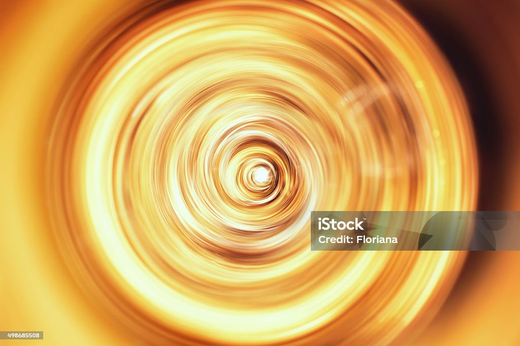 golden tornado in motion Golden tornado in motion, view from above, studio shot. The tornado is spinning in circles around a bright spot.  Gold - Metal Stock Photo