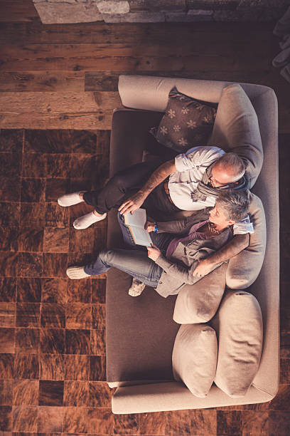Senior Couple Reading on Sofa stock photo