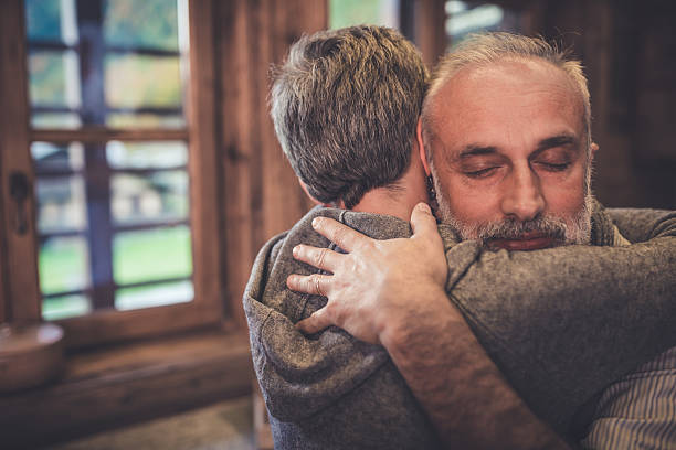 Senior couple embrace in kitchen