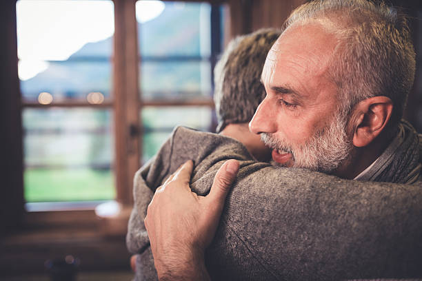 istock Senior couple embrace in kitchen 498686466