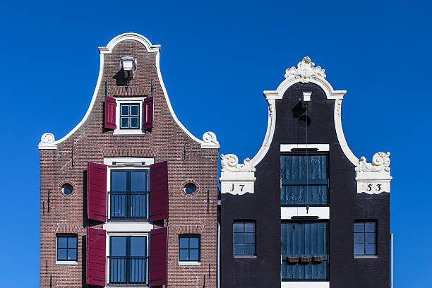 detail of two dutch canal houses in amsterdam - grachtenpand stockfoto's en -beelden