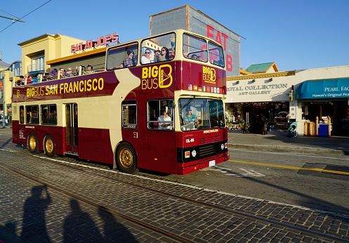 San Francisco, USA - May 28, 2014: People on a  tour bus with shadows of other visitors at Fisherman's Wharf in San Francisco.