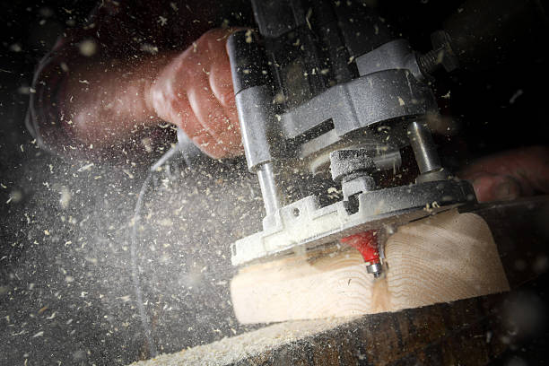 drill machine drilling a wood board stock photo