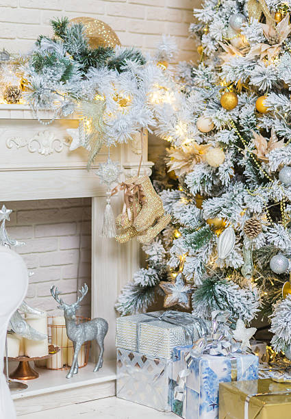 istock Brightly lit christmas tree with lots of gifts 498690520