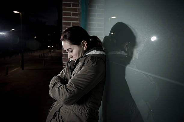 istock sad depressed woman alone leaning on street window at night 498691096